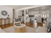 Bright and airy living room featuring an open floor plan, hardwood floors, and stylish decor at 1475 S Urban Way, Lakewood, CO 80228