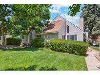 Charming home with a well-manicured lawn, mature trees, and lush landscaping at 2453 S Xanadu Way # C, Aurora, CO 80014