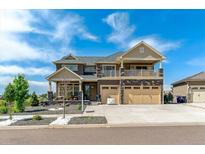 Beautiful two-story home boasts a large three-car garage, balcony, and landscaped front yard at 20503 E 50Th Pl, Denver, CO 80249