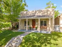 Charming home featuring a covered front porch with a swing and classic architectural details at 3929 Shoshone St, Denver, CO 80211