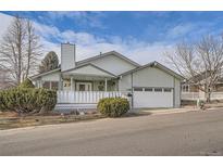 Ranch-style home with white porch and attached garage at 19 Carla Way, Broomfield, CO 80020