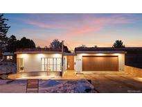 Charming modern home featuring sleek lines, a wood garage door, and a well-manicured front yard at sunset at 2206 Alpine Dr, Boulder, CO 80304