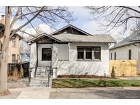 Charming, renovated bungalow with freshly painted white brick and beautifully landscaped front yard at 1018 Fillmore St, Denver, CO 80206