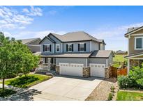 Beautiful two-story home featuring a three-car garage, landscaped yard, and a welcoming covered porch at 15602 E 117Th Ave, Commerce City, CO 80022