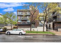 Brick building exterior with ample parking and landscaping at 830 N Sherman St # 106, Denver, CO 80203