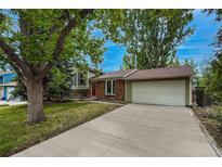 Charming home featuring a long driveway, brick accents, well-maintained lawn, and mature trees at 117 Sandler Dr, Lafayette, CO 80026