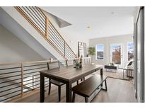 Bright dining room area featuring modern staircase and open-concept design, perfect for Gathering meals at 2620 S Delaware St # 3, Denver, CO 80223