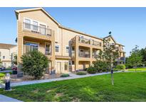Charming townhome showcases a private balcony and is surrounded by lush green landscaping at 11250 Florence St # 22B, Commerce City, CO 80640