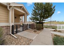 Inviting home with a stone facade, covered porch, and professional landscaping for great curb appeal at 1761 S Buchanan Cir, Aurora, CO 80018