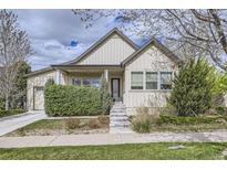 Charming home with manicured lawn, flowering shrubbery, concrete stairs and inviting front porch at 19 S 45Th Ave, Brighton, CO 80601