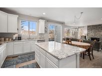 Modern kitchen with island and open layout to the living room at 3378 Shoveler Trl, Castle Rock, CO 80104