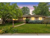 Charming single-story home with a well-manicured lawn and inviting walkway at 2309 E Floyd Pl, Englewood, CO 80113