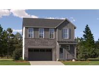 Charming two-story home with a stone and gray wood facade, complemented by a well-manicured lawn and professional landscaping at 2188 S Haleyville Way, Aurora, CO 80018