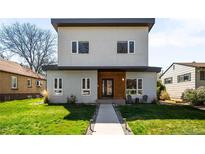 Contemporary two-story home with a minimalist design, well-manicured lawn, and inviting walkway at 1265 Niagara St, Denver, CO 80220