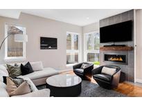 Bright living room with a modern fireplace, sleek furniture, and large windows, creating a cozy and stylish space at 1265 Niagara St, Denver, CO 80220