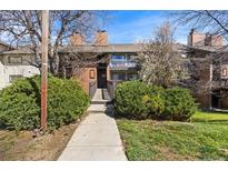 Charming brick condo featuring a walkway entrance, balcony, and well-maintained landscaping at 14602 E 2Nd Ave # 204C, Aurora, CO 80011