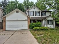 Charming two-story home featuring a two-car garage and mature trees in a Gathering-friendly neighborhood at 2477 S Oakland Cir, Aurora, CO 80014