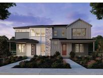 Modern home showcasing a gray and white color scheme, stone accents, and professionally landscaped front yard at 8886 Yellowcress St, Littleton, CO 80125