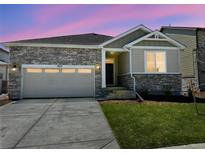 Charming single-Gathering home featuring stone accents, a two-car garage, and a well-manicured lawn at 1957 S Coolidge Way, Aurora, CO 80018
