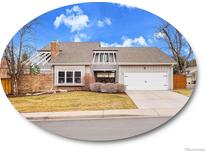 Charming home with a two-car garage and manicured front yard at 3706 E Easter Dr, Centennial, CO 80122