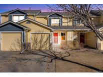 Two-story townhome with attached garage and landscaping at 410 Smith Cir, Erie, CO 80516