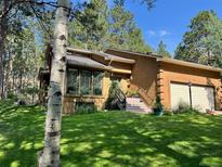 Charming home with a well-maintained lawn and inviting curb appeal at 85 S Sherwood Gln, Monument, CO 80132