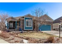 Charming home showcasing a blue exterior, a well-maintained yard, and mature landscaping at 8802 E 148Th Ln, Thornton, CO 80602