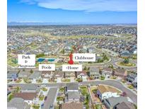 Community aerial view showcasing pool, playground, clubhouse, and single-Gathering homes with mountain views at 22441 E Chenango Dr, Aurora, CO 80015