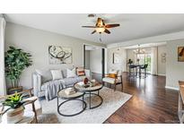 Inviting living room featuring modern decor, stylish furniture, and hardwood flooring throughout at 1047 Scranton St, Aurora, CO 80011