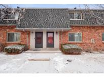 Charming brick townhouse with well-maintained landscaping and snowy winter scenery at 15123 E Wesley Ave, Aurora, CO 80014