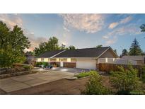Inviting exterior view of a single-story home with a well-manicured front yard, driveway, and attached two-car garage at 7600 Kline Dr, Arvada, CO 80005