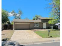 Charming single-Gathering home featuring a two-car garage, a well-maintained lawn, and a classic mailbox on a sunny day at 15650 E Eldorado Dr, Aurora, CO 80013