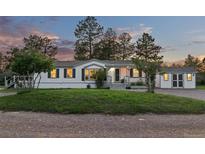 Charming single story home with white siding, dark shutters and a covered porch at 652 Verdos Dr, Elizabeth, CO 80107
