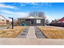 Charming home featuring a dark exterior, landscaped yard, and inviting entryway at 1381 Mariposa Dr, Denver, CO 80221