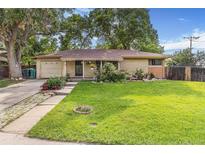 Charming ranch-style home with a well-maintained lawn and colorful flowerbeds enhancing the curb appeal at 111 S Eaton St, Lakewood, CO 80226