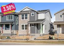 Two-story modern home with light gray and stone accents at 21239 E 62Nd Ave, Aurora, CO 80019