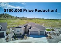 Charming single-Gathering home featuring a manicured yard and a two-car garage and $100,000 price reduction at 547 Scrubjay Cir, Castle Rock, CO 80104
