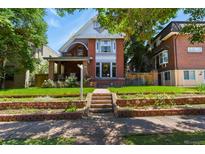 Charming brick two-story home with landscaped front yard and inviting curb appeal in a desirable neighborhood at 1160 York St, Denver, CO 80206