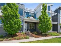 Inviting two-story home with modern siding, an attractive porch, and well-maintained landscaping at 4958 Valentia Ct, Denver, CO 80238
