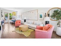 Chic living room with hardwood floors, designer furnishings, and abundant natural light at 4958 Valentia Ct, Denver, CO 80238