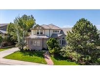 Charming two-story home with brick and siding exterior, mature trees, and a well-manicured lawn at 888 Northern Way, Superior, CO 80027