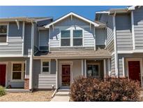 Charming two-story home with gray siding and a cozy front porch at 19043 E 58Th Ave, Denver, CO 80249