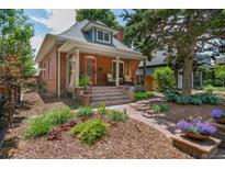 Charming brick home with a landscaped front yard and covered porch seating area at 3182 W 29Th Ave, Denver, CO 80211
