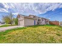 Charming home featuring an attached garage and a well-maintained lawn at 598 Arden Cir, Highlands Ranch, CO 80126