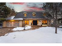 Charming brick home featuring a distinctive roof, attached garage and a welcoming brick path leading to the entrance at 6382 S Zenobia Ct, Littleton, CO 80123
