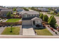 Beautiful two story home with a well maintained yard and attached two car garage in a desirable community at 25106 E 1St Ave, Aurora, CO 80018