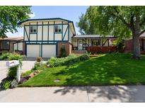 Charming two-story home with well-maintained lawn, lush landscaping, and a two-car garage at 10520 W 101St Pl, Westminster, CO 80021