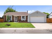Charming single-Gathering home with a well-manicured lawn and attached two-car garage at 11323 Albion St, Thornton, CO 80233