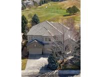 An aerial view of a beautiful property backing onto a golf course with mature trees at 10260 Longview Dr, Lone Tree, CO 80124