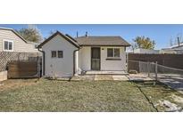 Charming home featuring a low-maintenance lawn and a secure fenced yard at 3336 S Clay St, Englewood, CO 80110